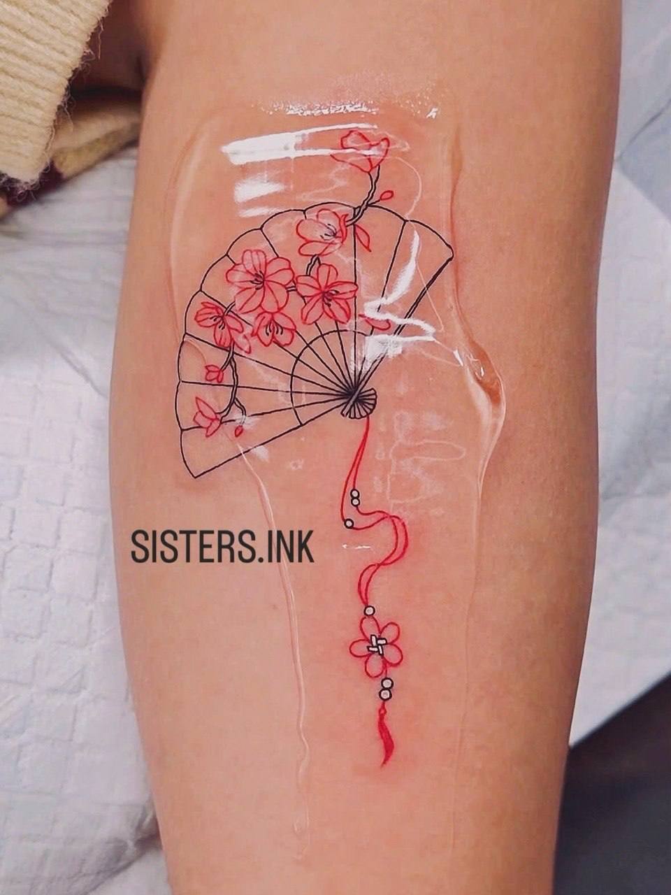 Red cherry blossom fan fine-line tattoo - Sisters Ink Tattoo Studio Da Nang
